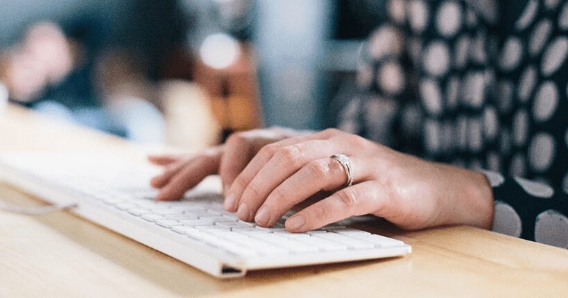 woman typing on a keyboard