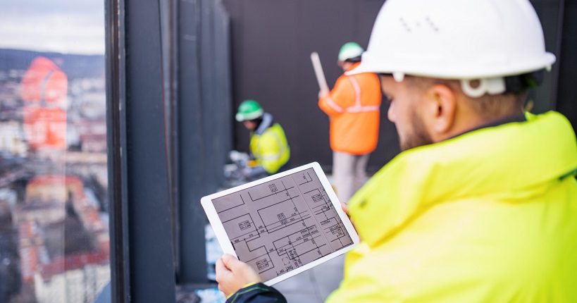 property maintenance manager at work holding a tablet